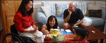 Photo: Family at a table playing a board game