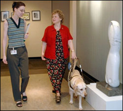 Photo: Two women, with a guide dog leading one