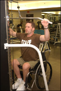 Photo: Disabled person working out in a gym