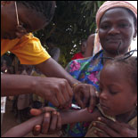 Photo: A child is vaccinated during a measles campaign in Benin, Africa