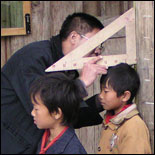 Photo: Health worker measures height of Chinese schoolchildren as part of nutritional assessment