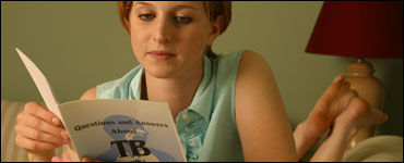 Photo: A woman reading about Tuberculosis