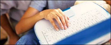 Photo: Typing on a laptop.