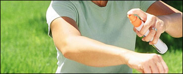 Photo: A woman applying insect repellent