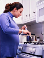 Photo: A pregnant woman preparing a healthy meal.
