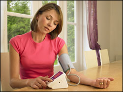 Photo: Woman checking her blood pressure