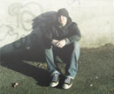 photo of young offender sitting by a graffiti wall – for SAMHSA News story on CSAT and YORP programs