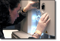 Researcher monitoring a sequencing machine