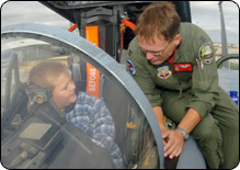 photo of a National Guard member showing a boy the instruments on an F-15 Eagle plane on Young American Day