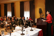 The symposium audience listens to Sonya Medina's opening remarks.