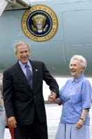 President George W. Bush met Grace McCarthy upon arrival in Marquette, Michigan, on Tuesday, July 13, 2004. McCarthy, 83, is an active volunteer in her community who has servedover 4,000 hours with the Retired and Senior Volunteer Program, an organization that enriches the lives of seniors by matching their interests with needs in the community.