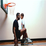 Father and son playing basketball.