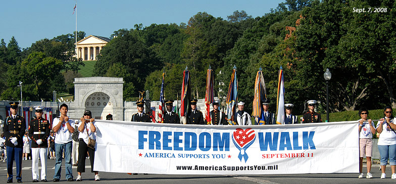 People hold a Freedom Walk banner as they prepare to walk from Arlington National Cemetery in Virginia to the Pentagon during the 2008 National America Supports You Freedom Walk at the Women in Military Service Memorial at Arlington National Cemetery, Va., Sept. 7, 2008. Thousands of people turned out for this year's Freedom Walk, which is a national tradition that calls on people to reflect on the lives lost on Sept. 11, 2001, remember those who responded, honor America's veterans past and present and renew the nation's commitment to freedom and the values of our country.