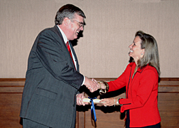 White House Homeland Security Advisor Frances Fragos Townsend presents Cingular Wireless President and Chief Executive Officer Stanley T. Sigman with a scroll representing his selection as a member of the President’s National Security Telecommunications Advisory Committee (NSTAC) during the NSTAC Executive Session held May 11 in Washington. Mr. Sigman represents the Cellular Telecommunications and Internet Association on the 30-member committee. 