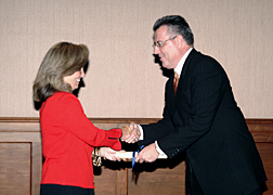 White House Homeland Security Advisor Frances Fragos Townsend presents Greg Brown, President of Motorola’s Government and Enterprise Mobility Solutions, with a scroll representing his selection as a member of the President’s National Security Telecommunications Advisory Committee (NSTAC) during the NSTAC Executive Session held May 11 in Washington.