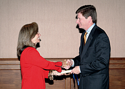 White House Homeland Security Advisor Frances Fragos Townsend presents AT&T President and Chief Operating Officer William J. Hannigan with a scroll representing his selection as a member of the President’s National Security Telecommunications Advisory Committee (NSTAC) during the NSTAC Executive Session held May 11 in Washington. 