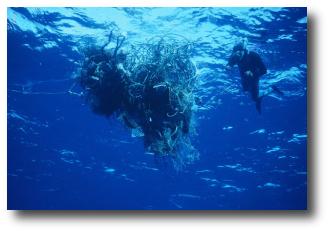 A scuba diver is shown next to a ball of tangled fishing gear.