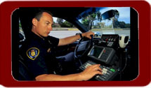 Image of police officer using communications equipment in his car