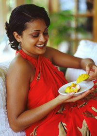 photo of woman eating mango