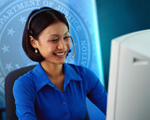 Photograph of woman with headset at computer