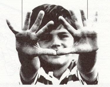 Photo of child who is showing the viewer his clean hands.