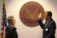 Luis Aguilar (left) is sworn in as SEC Commissioner