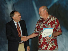 Jack Dangermond (left), President of ESRI, congratulates OSM’s Greg Morlock on the bureau’s vision and leadership in using geographic information systems (GIS) to make the Nation’s coal mines safer for the public and to help protect the environment.   Morlock accepted the Special Achievement in GIS (SAG) Award on behalf of OSM’s team working to build a central repository for boundaries of abandoned and active coalmines. OSM Photo