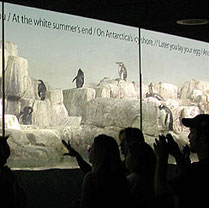 Central Park Zoo visitors read poetry while viewing penguins.