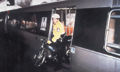 Photo of policeperson with bicycle getting off the subway