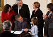 After signing a proclamation recognizing October as Domestic Violence Month, President George W. Bush shakes hands with Monique Blais, 7, the young artist who designed the Stop the Violence postage stamp in the East Room Wednesday, Oct. 8, 2003.