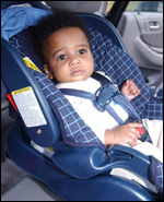 Photo: Shows an infant who has been properly positioned, and buckled into a rear-facing infant-only car seat.