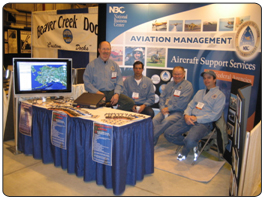 AMD Staff exhibiting at The Tenth Annual Alaska State Aviation conference in Anchorage, Alaska.  Photographed are: from left to right: John Pibbenow, Daryl Carson, Bud Walters, and Patrick Clark.