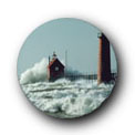 photo of large waves against lighthouse