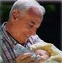 grandpa feeding baby