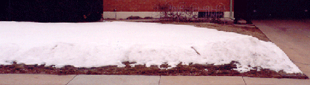 Snow on yard with thick grass.  Snow depth 15cm