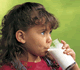 Little girl drinking a glass of milk