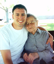 Welcome. This image shows a smiling young man with his arm around a smiling Medicare beneficiary.