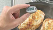 hands using a meat thermometer