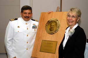 NOAA image of Peggy Dyson-Malson, widow of Oscar Dyson, presenting a plaque with Oscar Dyson's picture to Cmdr. Frank Wood, NOAA Corps, who will be the ship's first commanding officer.