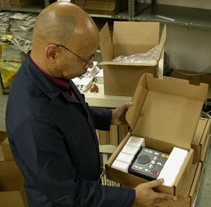 NLS warehouse foreman Kevin Cross prepares a digital talking-book player for shipping to Connecticut.
