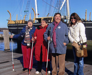 NLS patron Carol Gillispie with Louise Pillio, Janet Dudeck, and Cindy Kleszez in front of the Charles W. Morgan.