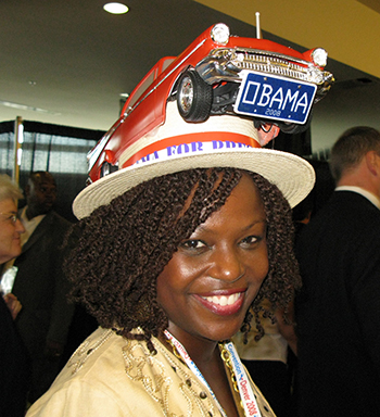 Image of woman delegate in hat with a car on it