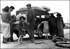    “America was Dickensian,” says Shlaes, while describing the hardships of the thirties. Her book The Forgotten Man strikes a responsive chord by depicting individual tragedy still occurring relatively late during the Depression. This family of pea pickers, halted near Santa Maria, California, in their migratory search for work, copes with changing a tire along US Route 101 in 1936..
			
—Photo by Dorothea Lange. Getty Images