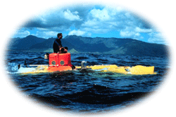 Crewmember sits atop the Pisces Submersible prior to recovery