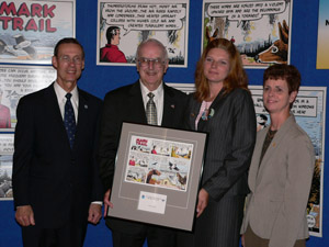 Kathryn Martin of Evansville, Ind., being presented with a Mark Trail Award by NOAA Administrator Conrad C. Lautenbacher, Mark Trail creator, Jack Elrod and Mary Glackin, acting director of the National Weather Service. 