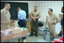 Photo thumbnail: Acting Surgeon General RADM Kenneth P. Moritsugu visits the temporary provider site Moulton Methodist School in Trinidad and speaks with pharmacy personnel.