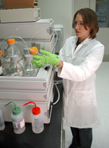 NIST research chemist Mary Bedner prepares to use liquid chromatography and mass spectrometry to analyze the chemical byproducts produced by reacting pharmaceuticals with chlorine.