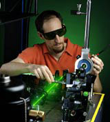 Electrical engineer Richard Mirin aligns a laser used in an apparatus for producing a stream of single photons. 