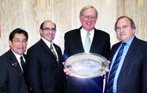 Clark de Schweinitz, holding award, stands with (from left) New Mexico State Bar President-Elect Henry Alaniz, Supreme Court Chief Justice Edward Chavez, and Attorney General Gary King.