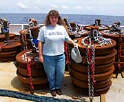 Teacher at Sea Jennifer Richards stands in front of buoys 